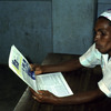 Literacy, woman reading a newspaper, adult education