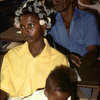 Literacy, class for adults, adult education. Woman with little child