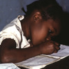 A young girl writing.