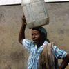 Everyday life, water gathering, woman carrying water, bucket