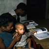 Literacy courses for women, adult education. Woman with little child