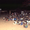 Outdoor movie show in a village, African audience, screen