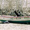 Small boat on the sea shore under the pier, slavery