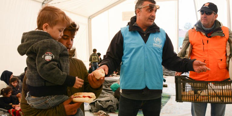 Mohammed Arouki is seconded from NORCAP to support UNs response to the crisis in Greece. Here he is distributing food to refugees who have just arrived in Chios together with Nicholas Panteloukas from NRC. Photo: Tiril Skarstein, NRC