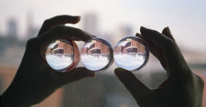 Three glass spheres reflecting the same reality.