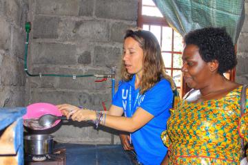 UN Volunteer Serena testing a biogaz installation in the framework of the ‘safe access to fuel and energy’ approach to reduce environmental impact of cooking needs through the production and use of durable clean energy. Credits UNH