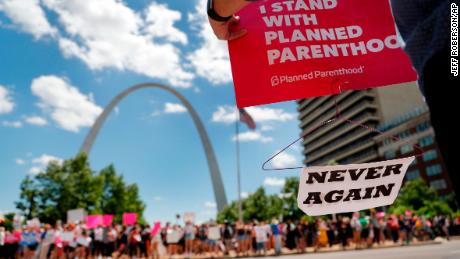 Abortion-rights supporters stand on both sides of a street near the Gateway Arch as they take part in a protest in favor of reproductive rights Thursday, May 30, 2019, in St. Louis. A St. Louis judge heard an hour of arguments Thursday on Planned Parenthood&#39;s request for a temporary restraining order that would prohibit the state from allowing the license for Missouri&#39;s only abortion clinic to lapse at midnight Friday. (AP Photo/Jeff Roberson)