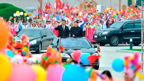 In this Thursday, June 20, 2019, photo provided by the North Korean government, North Korean leader Kim Jong Un, right, and Chinese President Xi Jinping acknowledge welcoming people on a street in Pyongyang, North Korea. The content of this image is as provided and cannot be independently verified.  (Korean Central News Agency/Korea News Service via AP)