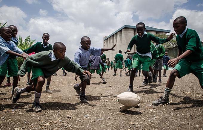 Children play football at a low-cost informal school in Nairobi. Research by APHRC has helped the Government of Kenya develop policies on school access. © African Population and Health Research Centre