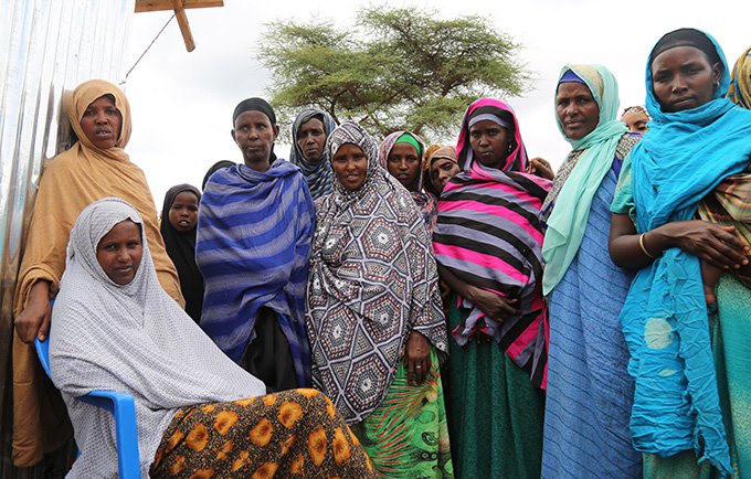Dulene Trik (sentada) con unas amigas en el campamento de desplazados Kologe II. Ella instruye a las mujeres acerca de la planificación familiar. © UNFPA Etiopía