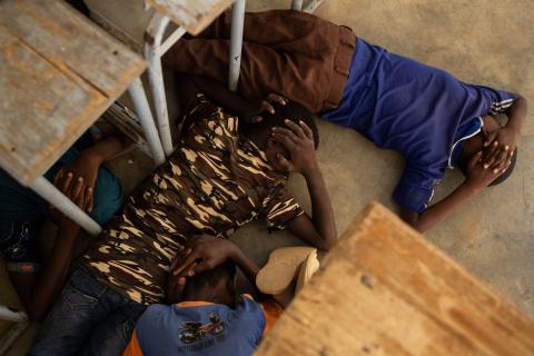 On 26 June 2019, children take part in an emergency attack simulation, as they practice sheltering and evacuation in the event of an armed attack, at the Yalgho Primary School in Dori, Burkina Faso.