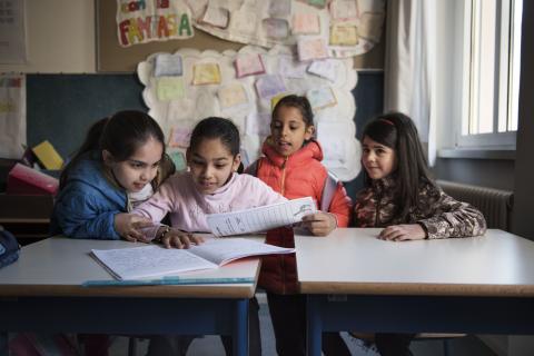 Nine-year-old Syrian refugee Badiaa sits at a desk with Italian and Syrian friends in her classroom at a public elementary school in Trento, Trentino province, Italy, Tuesday 2 May 2017