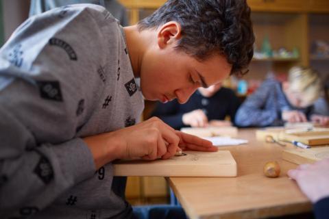 Volodymyr Charushyn, 16, at the wood carving lesson at his education complex for children with hearing disabilities in Ukraine He is a grantee of UPSHIFT Ukraine, an innovative programme aimed at developing entrepreneurship skills among adolescents and youth as agents of social change.