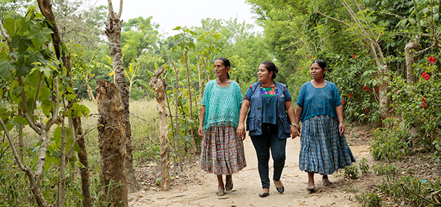 Indigenous women walk along a road in Guatemala. Photo: UN Women/Ryan Brown