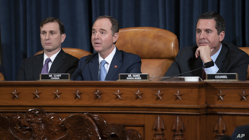 House Intelligence Committee Chairman Adam Schiff, D-Calif., center, flanked by Daniel Goldman, director of investigations