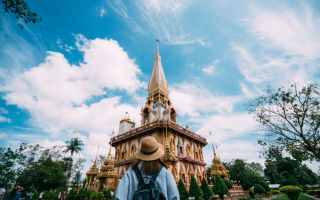 A traveler visits the pagoda at Wat Chalong in Phuket Thailand. Getty / MongkokChuewong 