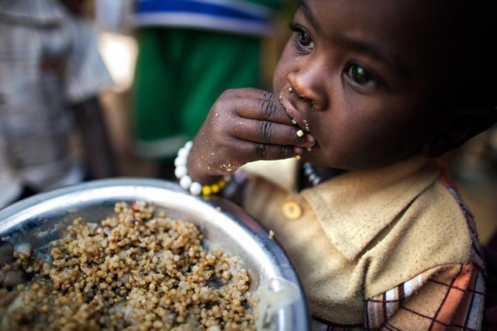 A child has a meal at a food distribution centre in the Rwanda camp for internally displaced persons (IDPs), near Tawila, North Darfur. More than 8,000 women and children living in the camp benefit from nutrition programmes run by the World Food Programme