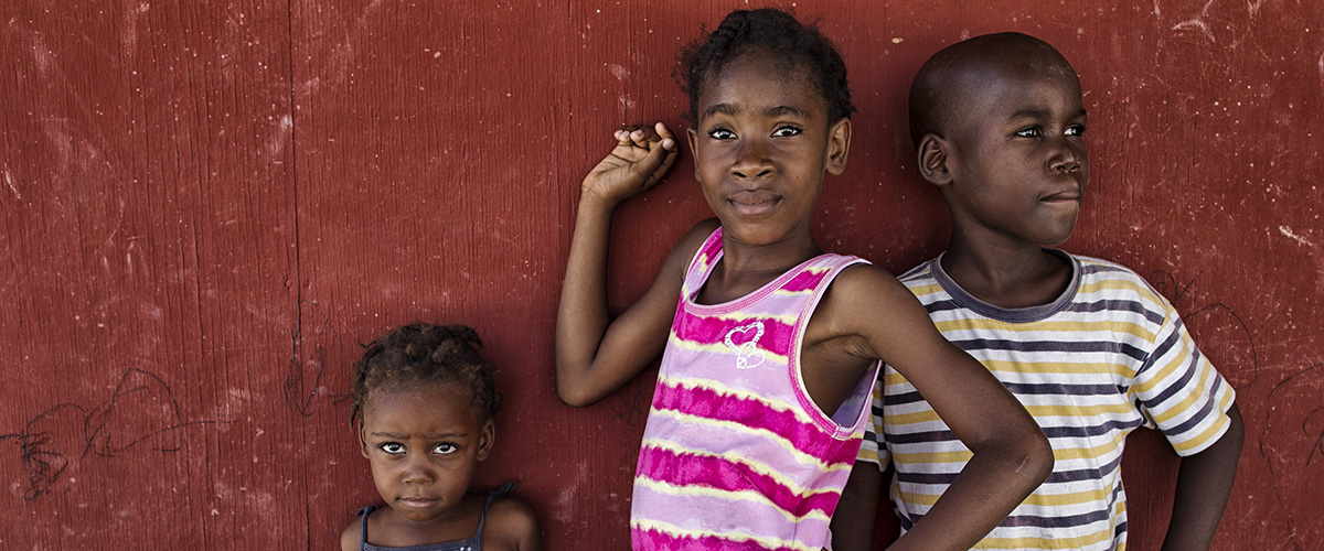 Children pose in a camp for internally displaced people in Haiti.