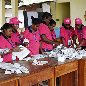 Polling officers tally votes after ballots were cast in Timor-Leste's parliamentary elections (2012). 
