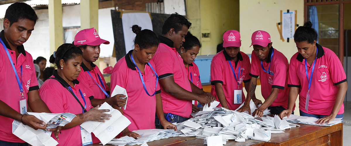 Polling officers tally votes after ballots were cast in Timor-Leste's parliamentary elections (2012). 