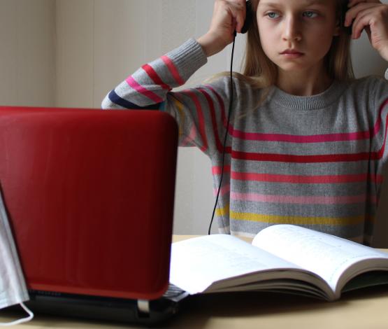 image of child at laptop with facemask
