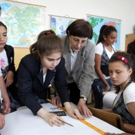 May 8, 2013 - Romania. History teacher (center) helps her students during class exercise at the Scoala Frumusani School in the village of Frumusani