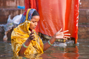 Unidentified woman wash herself in the river Ganga  in the holy city of Varanasi, India