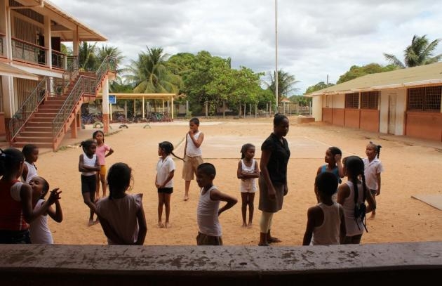 Students are playing in a schoolyard in Guyana. 