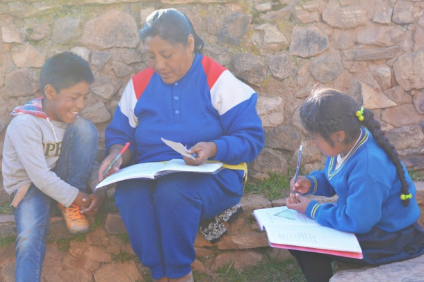 Mother and children writing on notebook