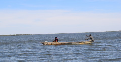 2 persons on traditional canoe on Lake Chad