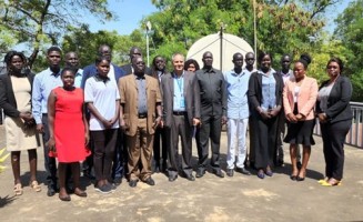 The Information commissioner (C), UNESCO Education Specialist ( C) and Public Information Officers pose for a group photo at  AMDISS, in Juba