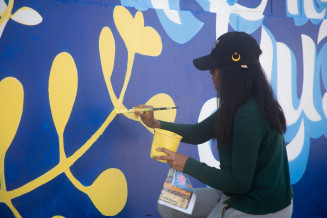 A girl painting on the wall