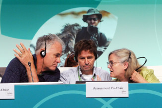 3 people discussing New assessment of the multiple values of nature and its benefits during IPBES congress