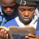 School kids studying an indigenous language religious book