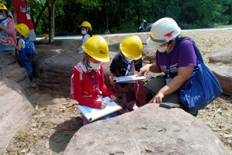 School children look for fossils during an educational activity in Khorat UNESCO Global Geopark, Thailand