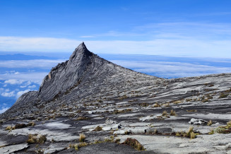 Hornblende Granite peak in the Kinabalu UNESCO Global Geopark, Malaysia. The hornblende granite, characterised by the presence of fine-grained hornblende minerals, occurs on the inner part of the Kinabalu pluton and can be seen along the summit trail from Laban Rata to Low’s Peak.