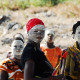 Makua women, with traditional white face mask 