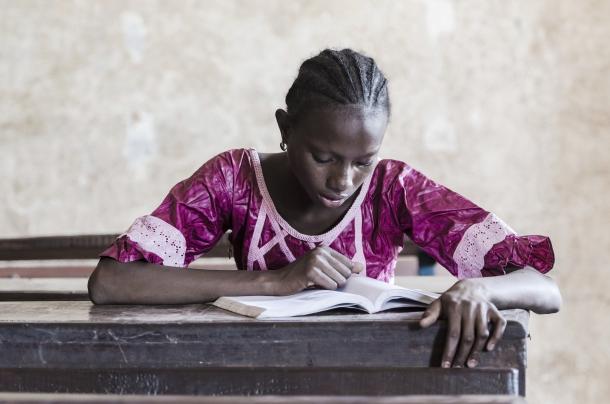 African youth reading a book