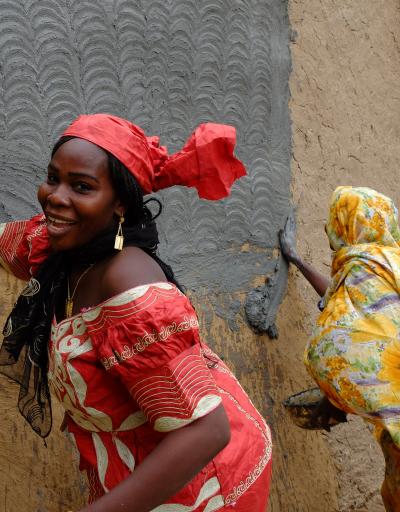 Women decorating wall in Cameroon